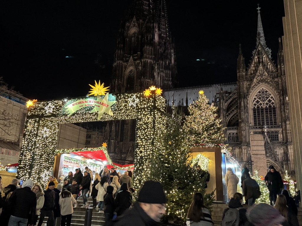 The illuminated entrance to the Cologne Cathedral Christmas market in Germany at night