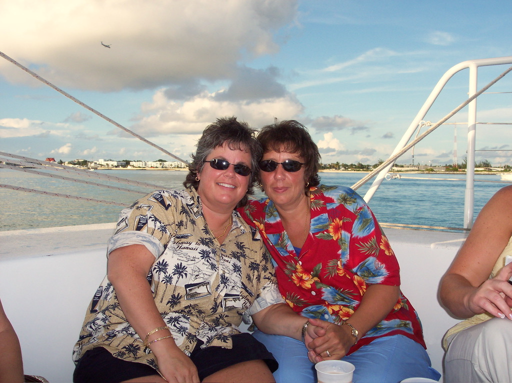 Anne Conrad and her wife Kathy holding hands on a sunset sail on their honeymoon in Key West