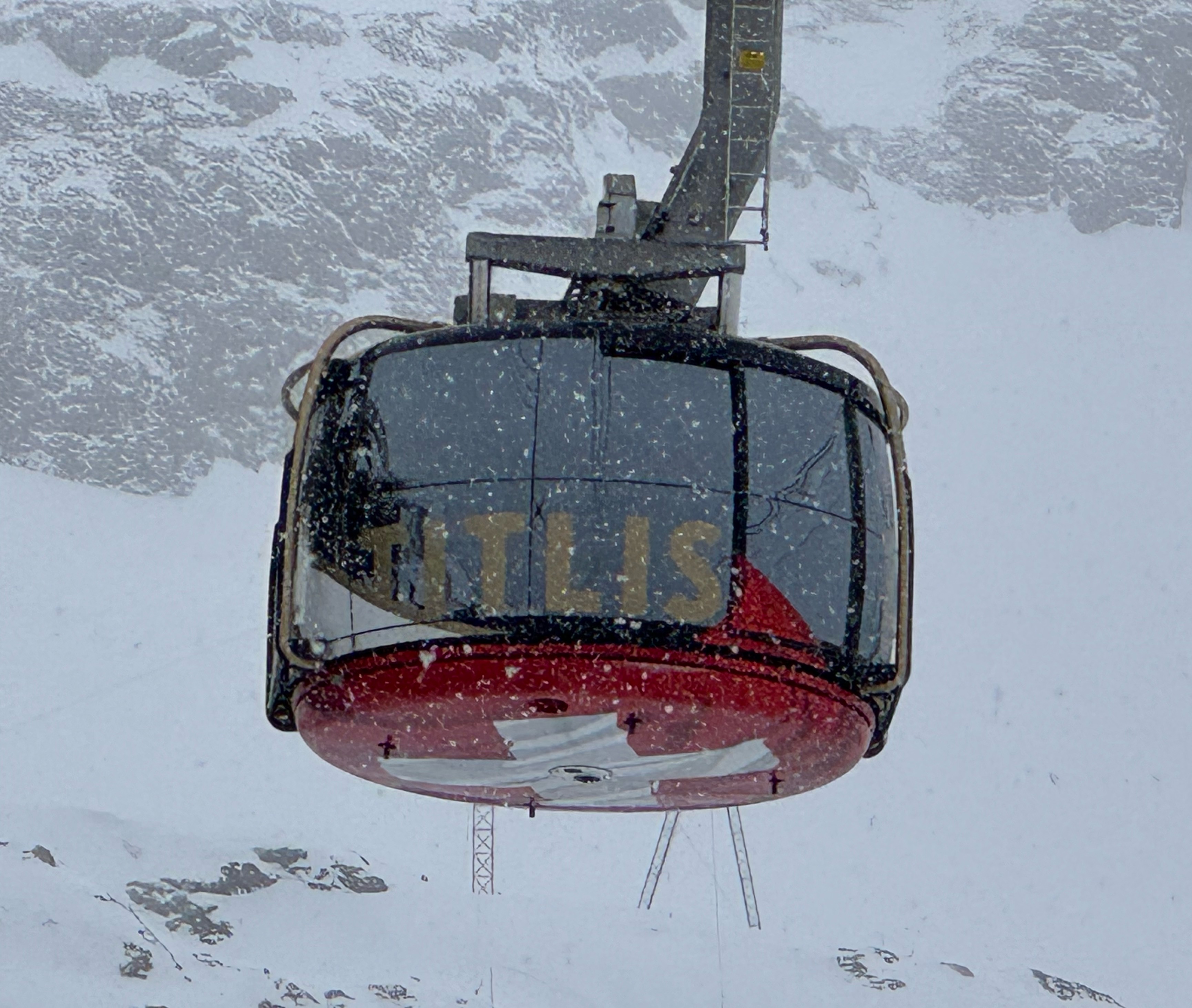 The red Rotair rotating gondola on Mount Titlis, Switzerland, in falling snow